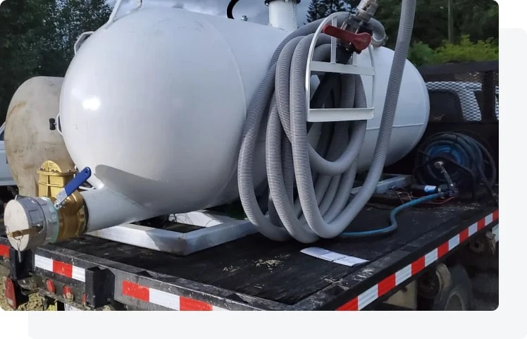 Technician reviewing septic service conditions at a residential site.